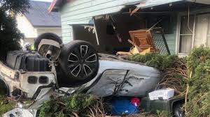 Two people had to be cut free after the car crashed into a house in Telarah Picture: dailytelegraph.com.au