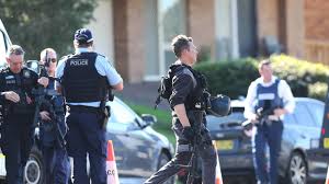Heavily armed police surrounded a home in Maryland Picture: dailytelegraph.com.au
