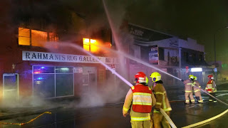 Firefighters tackle the flames at Rahmani's Rug Gallery in Parry Street Picture: FRNSW Media