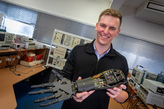 Electrical Engineering Graduate Sam Parker poses with his final year project.