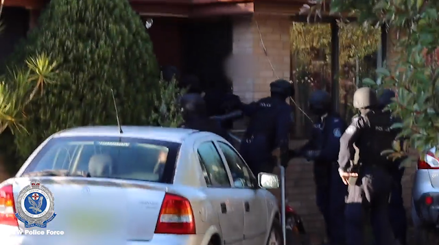 Police search a home at Mallabula on Thursday. Image: NSW Police.